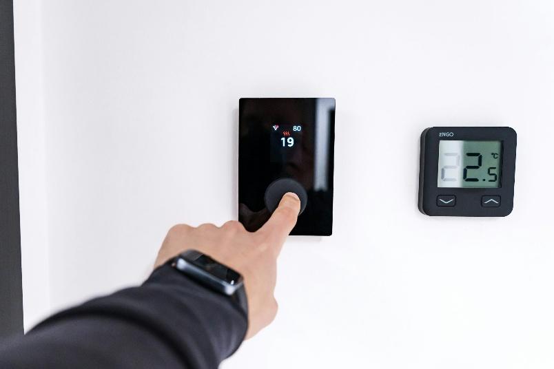 A professional testing a system after successful thermostat installation in Fresno