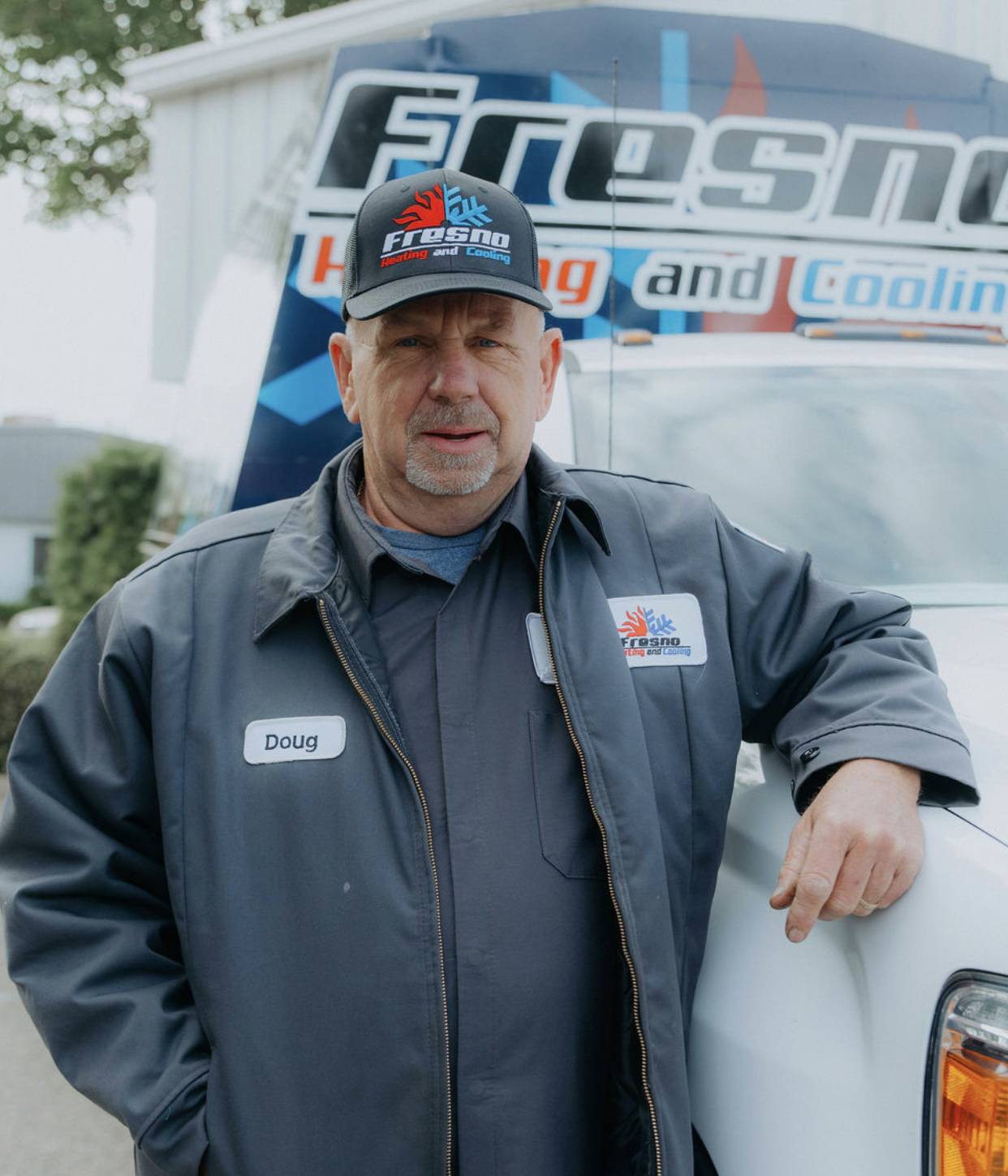Doug, sheet metal fabricator at Fresno Heating and Cooling, standing in front of a company service truck
