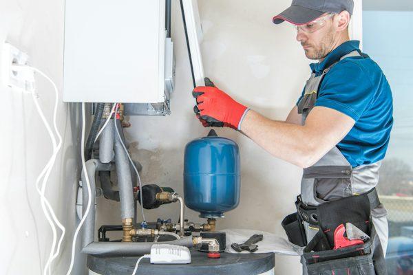Technician inspecting a residential water heater in California