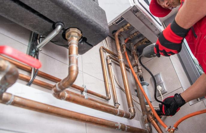 Expert working on routine commercial HVAC maintenance in California