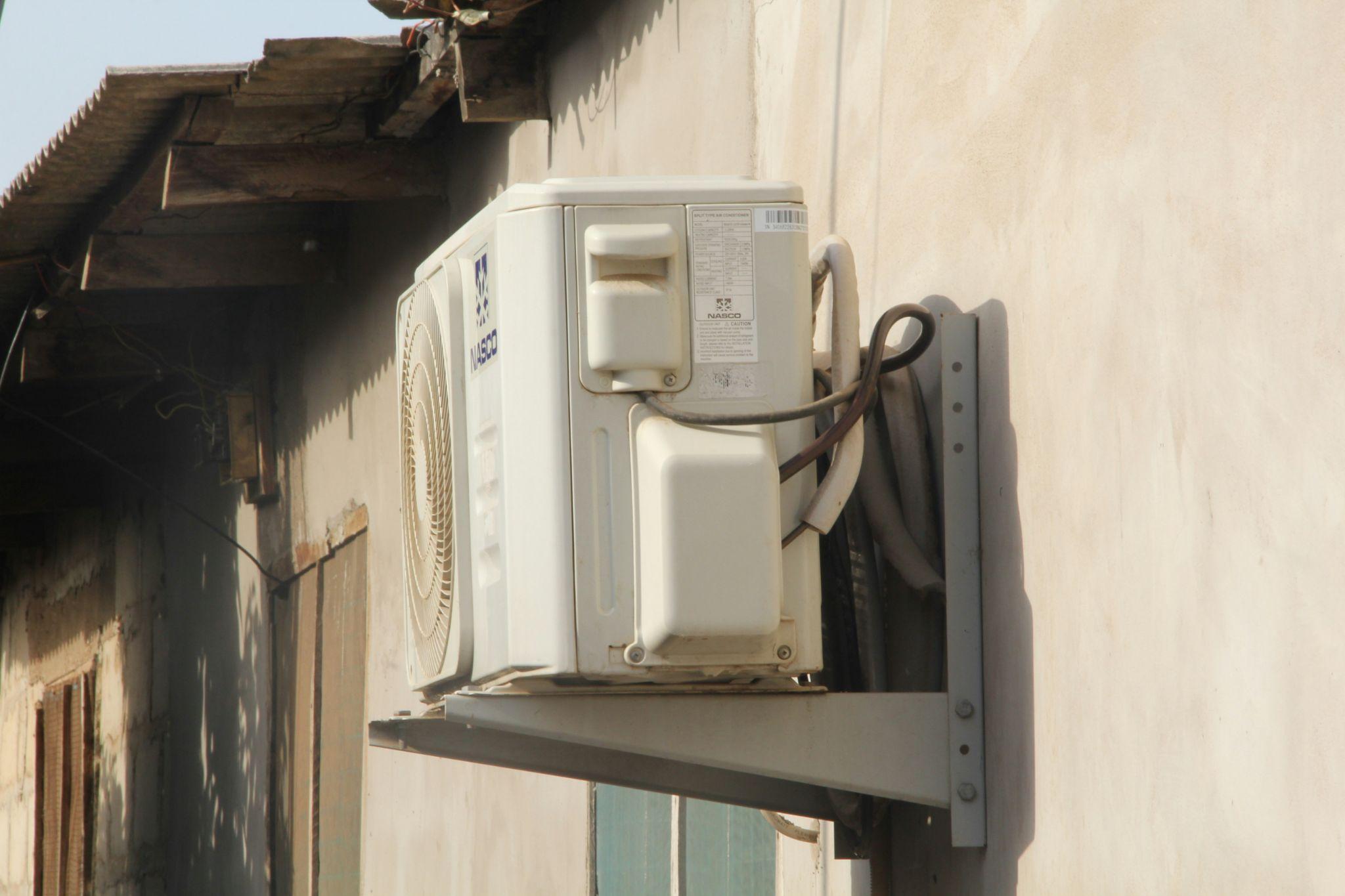 A wall-mounted outdoor air conditioning unit illustrates residential HVAC services in Fresno.