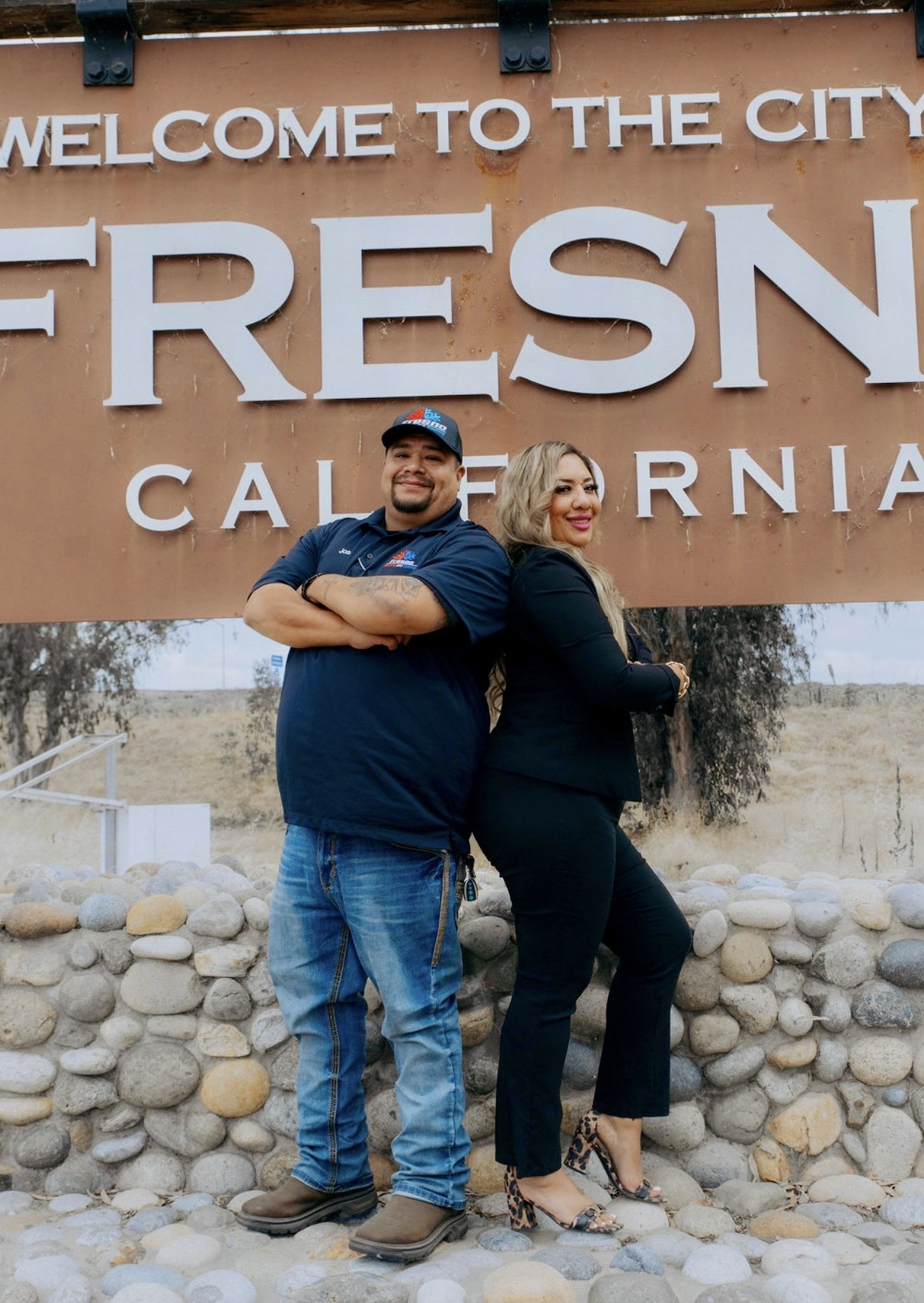 Fresno Heating and Cooling team gathered together in front of the Welcome to the City of Fresno sign