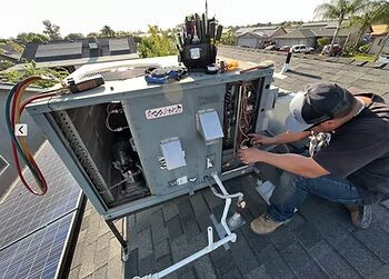 Technician performing preventative maintenance on an HVAC unit