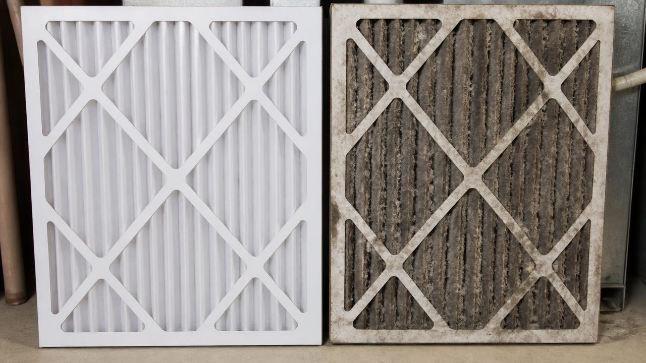Clean new HVAC air filter next to a dust-clogged dirty filter showing how airflow gets restricted